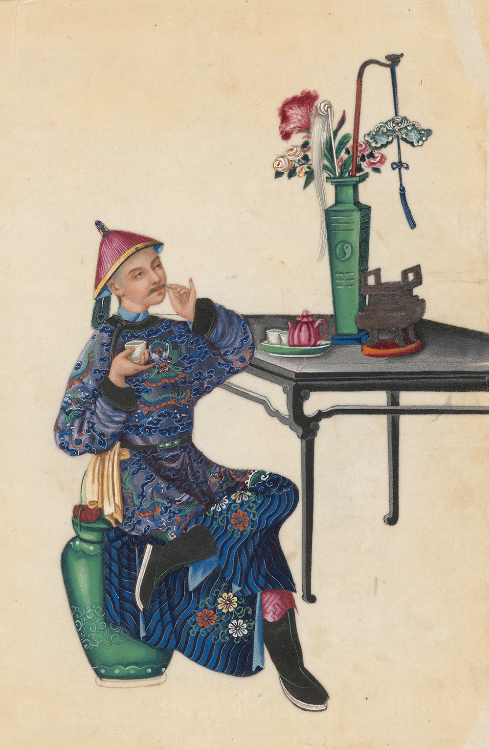 Man with cup of tea, stroking his mustache